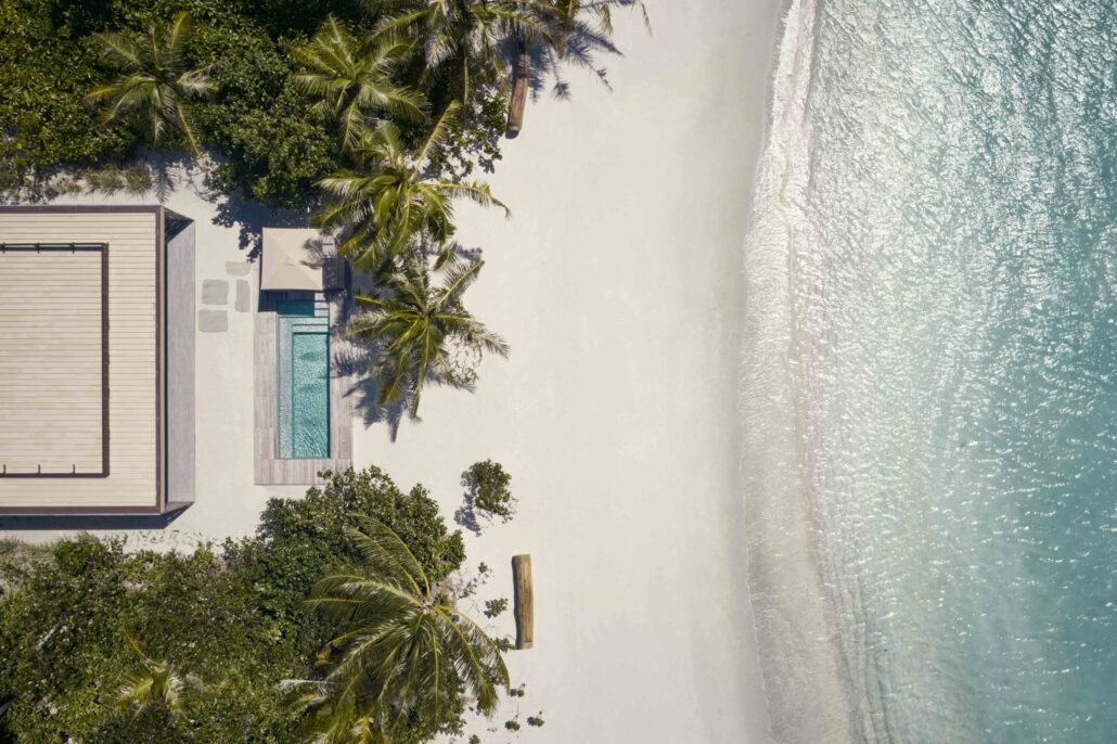 patina maldives villa one b sunset beach pool aerial scaled 1