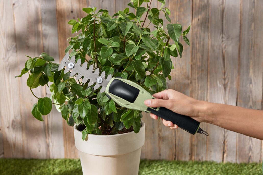 Kompakte Akku-Gartenschere in Hellgrün-Schwarz – ideal zum Schneiden von Gras und Sträuchern.