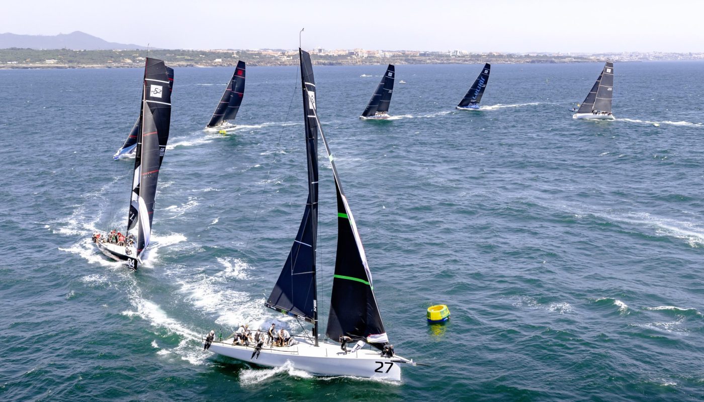 CLOSE COMPETITION AS THE FLEET APPROACHES THE WINDWARD MARK